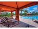 Resort-style swimming pool with lounge chairs, cabana and palm trees at 8433 Alberata Vista Dr, Tampa, FL 33647