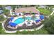 A resort-style pool is surrounded by palm trees and covered cabanas for a luxurious outdoor experience at 8433 Alberata Vista Dr, Tampa, FL 33647