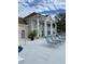 Community clubhouse with lounge chairs, large windows, and well-maintained landscaping at 850 S Tamiami Trl # 424, Sarasota, FL 34236