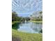Scenic pond with fountain surrounded by lush landscaping and community buildings at 850 S Tamiami Trl # 424, Sarasota, FL 34236