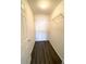 A walk-in closet has dark wooden flooring and wire shelving to create lots of storage at 850 S Tamiami Trl # 424, Sarasota, FL 34236