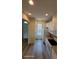 Bright kitchen with white cabinets, modern appliances, and wood-look flooring at 8814 Walnut Gable Ct, Riverview, FL 33578