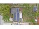 A high aerial view shows the house with backyard and solar panels and a white fence at 919 Alpine Dr, Brandon, FL 33510