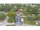 A high aerial view reveals solar panels atop a home surrounded by lush trees and neighborhood at 919 Alpine Dr, Brandon, FL 33510
