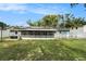 Home with a screened porch, fenced backyard, and solar panels on the roof at 919 Alpine Dr, Brandon, FL 33510