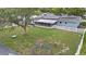 A backyard scene with a playground, screen porch and bordered with a white picket fence at 919 Alpine Dr, Brandon, FL 33510