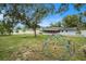 Large backyard with playground and a home with solar panels visible in the background at 919 Alpine Dr, Brandon, FL 33510
