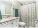 Bathroom with marble vanity, white cabinets, and shower with decorative curtain at 919 Alpine Dr, Brandon, FL 33510
