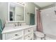 Bathroom featuring a vanity with drawers, a tile shower, and modern finishes at 919 Alpine Dr, Brandon, FL 33510