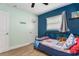 Cozy bedroom featuring wood-look floors and a basketball hoop at 919 Alpine Dr, Brandon, FL 33510