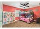 Colorful bedroom with bunk beds, storage, wood-look floors, and a ceiling fan at 919 Alpine Dr, Brandon, FL 33510