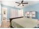 Well-lit bedroom featuring a ceiling fan, ensuite bath, and closet storage at 919 Alpine Dr, Brandon, FL 33510