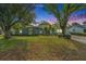 Charming single-story home featuring lush landscaping and mature trees in a well-maintained front yard at 919 Alpine Dr, Brandon, FL 33510