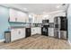 Modern kitchen featuring sleek countertops, stylish white cabinetry, and stainless steel appliances at 919 Alpine Dr, Brandon, FL 33510
