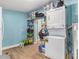 Functional laundry room with shelving, wooden flooring, and stacked washer/dryer at 919 Alpine Dr, Brandon, FL 33510