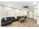 Cozy living room features comfortable seating and ample natural light through large windows at 919 Alpine Dr, Brandon, FL 33510