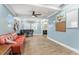A spacious living room is brightened by a ceiling fan and features durable tile flooring at 919 Alpine Dr, Brandon, FL 33510