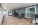Spacious porch with tile flooring, exercise equipment and a door to the backyard at 919 Alpine Dr, Brandon, FL 33510