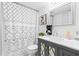 This bathroom has a sleek vanity and modern patterned shower curtain at 9481 Highland Oak Dr # 1504, Tampa, FL 33647