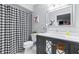 This bathroom has a sleek vanity and modern patterned shower curtain at 9481 Highland Oak Dr # 1504, Tampa, FL 33647