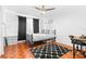 Cozy bedroom featuring black and white decor, wood floors, and comfortable furnishings at 9481 Highland Oak Dr # 1504, Tampa, FL 33647
