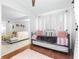 Daybed bedroom with sheer curtains and view into adjacent decorated living room at 9481 Highland Oak Dr # 1504, Tampa, FL 33647
