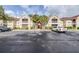 Exterior view of a condo building with reserved parking and palm trees at 9481 Highland Oak Dr # 1504, Tampa, FL 33647