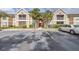 Exterior of the condo featuring reserved parking, second story screened patios, and tropical landscaping at 9481 Highland Oak Dr # 1504, Tampa, FL 33647
