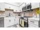 Bright condo kitchen featuring stainless steel appliances and a stylish tile backsplash at 9481 Highland Oak Dr # 1504, Tampa, FL 33647