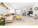 Open living area features a large white couch, adjacent small bedroom, and stylish decor at 9481 Highland Oak Dr # 1504, Tampa, FL 33647