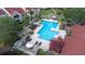 Community pool with plenty of lounge chairs and tropical landscaping at 9481 Highland Oak Dr # 1504, Tampa, FL 33647