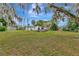 Expansive backyard with mature trees and the main house at 9615 Raiden Ln, Riverview, FL 33569