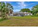 A spacious backyard featuring an in-ground screened pool and lush greenery at 9615 Raiden Ln, Riverview, FL 33569