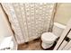 Bathroom area featuring tile floors, toilet, and shower with textured curtain at 9615 Raiden Ln, Riverview, FL 33569