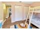 Bedroom featuring a bunk bed, colorful rug, and closet doors with a view to another room at 9615 Raiden Ln, Riverview, FL 33569