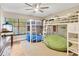 Bedroom showcasing bunk beds, neutral walls, wood floors, and cozy beanbag chairs at 9615 Raiden Ln, Riverview, FL 33569