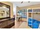 View of bunk beds with a dresser and fish tank near the window in the bedroom at 9615 Raiden Ln, Riverview, FL 33569