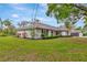 Well-maintained home featuring lush green lawn, mature trees and a detached garage at 9615 Raiden Ln, Riverview, FL 33569