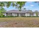 Charming single story home featuring black shutters and manicured front yard landscaping at 9615 Raiden Ln, Riverview, FL 33569