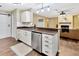 Bright kitchen featuring updated stainless steel appliances, hardwood flooring, and a breakfast bar at 9615 Raiden Ln, Riverview, FL 33569