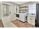 Laundry room with shelving, washer and dryer, utility sink, and decor at 9615 Raiden Ln, Riverview, FL 33569