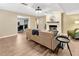 Cozy living room featuring hardwood floors, a fireplace, and a comfortable seating arrangement for relaxation and socializing at 9615 Raiden Ln, Riverview, FL 33569