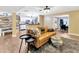 Open-concept living room showcasing modern decor, hardwood floors, and seamless flow to the kitchen and dining area at 9615 Raiden Ln, Riverview, FL 33569