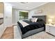 Spacious bedroom with a large window, hardwood flooring, and comfortable decor at 9615 Raiden Ln, Riverview, FL 33569