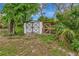 A backyard outbuilding with a screened chicken coop at 9615 Raiden Ln, Riverview, FL 33569