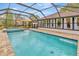 A refreshing pool featuring brick pavers and a screened enclosure for year-round enjoyment at 9615 Raiden Ln, Riverview, FL 33569