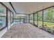 Screened in porch with brick flooring and a view of the pool and backyard at 9615 Raiden Ln, Riverview, FL 33569