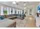 Bright sunroom with large windows, tile floors, and comfortable seating, ideal for enjoying natural light and outdoor views at 9615 Raiden Ln, Riverview, FL 33569