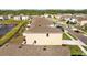 Aerial view of the backyard with patio seating and a small yard surrounded by neighboring homes at 16121 Soft Fern Trace, Odessa, FL 33556