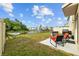 Backyard features grill, seating, patio, metal fence, and view of the pond with fountain at 16121 Soft Fern Trace, Odessa, FL 33556